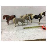 Four plastic horse toys