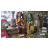 Wooden Carvings Featuring Figurine and Pineapple