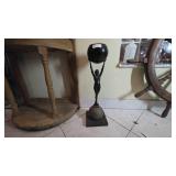 Metal Statue Holding a Black Sphere
