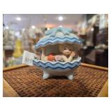 Baby nestled inside a blue & white clamshell or