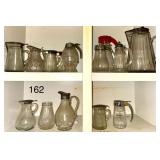 ASSORTMENT OF ANTIQUE TO VINTAGE GLASS SYRUP DISPENSERS AND PITCHERS
