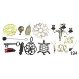6 PIECES OF CAST IRON: CHILDREN’S TOY STEAM IRON, 2 /RIVETS, CANDLE SNUFFER, KEY HANGER, OTHER WALL HANGING; 8 PIECES OF BRASS: 4 TRIVETS, WALL SCONCE, CANDLE SNUFFER, AND OTHER ACCESSORIES; PORCELA