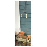 CONCRETE PLANTER, CLAY POTS, WROUGHT IRON SHEPHERD’S HOOKS, TIKI TORCHES, AND BIRDHOUSES