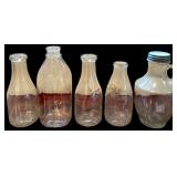 4 VINTAGE GLASS MILK BOTTLES: 1 BILTMORE DAIRY FARMS, 2 MARKED 1 QUART, 1 OTHER; HALF GALLON GLASS JUG
