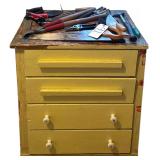 VINTAGE WOODEN 4-DRAWER CABINET W/ SMALL ASSORTMENT OF HAND TOOLS: HANDSAW, HATCHET, TROWEL, SNIPS, FLATHEAD SCREWDRIVER, PAIR OF GLOVES, ETC.