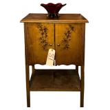 HAND DECORATED SMALL WOODEN 2-DOOR CABINET WITH RED TO CLEAR ART GLASS BOWL APPROX. 31” TALL