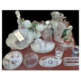 LARGE LOT OF CLEAR GLASSWARE TO INCLUDE 2 AVON BOTTLES, CANDLEHOLDER W/ GLASS GLOBE, LEAF PATTERN PITCHER W/ 2 MATCHING CUPS, PATTERN GLASS OVULAR BOWLS, PATTERN GLASS COASTERS, BRASWELL’S SELECT DR