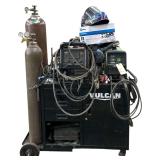 VULCAN WELDING CART W/ TITANIUM PLASMA 65 WELDER, VULCAN OMIPRO 220 WELDER W/ FOOT PEDAL, MILLER COOLBELT HELMET, WELDING CONSUMABLES, 2 GAUGES - TANKS NOT INCLUDED