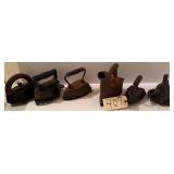 FIVE VINTAGE SAD IRONS AND ONE COAL IRON