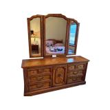 WOODEN DRESSER W/ 6 DRAWERS, 1 DOOR W/ 3 DRAWERS INSIDE - APPROX. 70” WIDE X 31.25” TALL X 18” DEEP - W/ TRI-FOLD MIRROR - MATCHES LOT #189