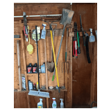 ASSORTMENT OF TOOLS TO INCLUDE SQUARE SHOVEL, SPADE SHOVEL, RAKE, BROOM, PITCH FORK, PRUNERS, MOTOR OIL, BAR & CHAIN OIL, GRILL BRUSH, CAMPING SAW, SNOW SHOVEL, ETC.