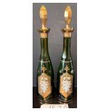 2 TALL VINTAGE GREEN GLASS BOTTLES WITH APPLIED TRIM AND GOLD DECOR; BOTH WITH SLIGHTLY DIFFERENT STOPPERS