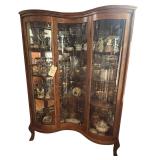 VINTAGE 1980S/1990S OAK INVERTED-CORNER CHINA CABINET WITH CONCAVE GLASS INSERTS; CONTENTS NOT INCLUDED