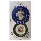 HANGING PLATE HOLDER WITH 2 PORTRAIT PLATES: BLUE PLATE APPROX. 10" DIAMETER AND GREEN PLATE APPROX. 8" DIAMETER; GREEN PLATE APPEARS TO BE VINTAGE