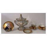VINTAGE FOOTED LIDDED JAR WITH HEAVY GOLD OVERLAY THAT APPEARS TO BE HAND-PAINTED; GOLD-TONE DEMITASSE CUPS AND SAUCERS; ANTIQUE HAND-PAINTED SMALL PORTRAIT PLATE