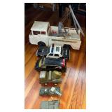 VINTAGE ERTL DIE-CAST A-TEAM VAN WITH HEAVY WEAR, APPROX. 11" LONG; FUNRISE 1991 PLASTIC POLICE CAR; VINTAGE PLASTIC WRECKER; BUDDY L DIE-CAST MILITARY SPOTLIGHT TRUCK; VINTAGE TIN-LITHOGRAPH MILITARY