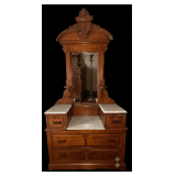 ANTIQUE WALNUT DRESSER WITH CANDLE STANDS, CARVED DETAIL, AND MARBLE TOP; APPROX. 42" WIDE X 20" DEEP X 7 FT. TALL