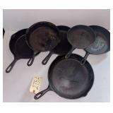 LOT OF VINTAGE CAST IRON SKILLETS: LARGEST MARKED SK NO. 10 USA; 2 NO. 5 SKILLETS, 8 1/8", INCLUDING 1 WAGNER WARE; 2 UNMARKED; 1 SHOWING RUST