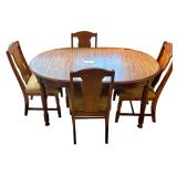WOODEN OVAL DINING TABLE W/ 12” LEAF AND 4 MATCHING UPHOLSTERED CHAIRS FEATURING CARVED WHEAT MOTIF BACKS - TABLE APPROX. 58” LONG X 38” WIDE, 70” LONG W/ LEAF; UPHOLSTERY SHOWING STAINING/WEA