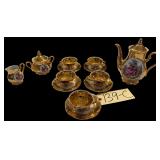 GOLD-GILDED PORCELAIN BAVARIA, GERMANY TEA POT FEATURING CLASSIC "COURTING COUPLE" SCENE: PITCHER, 5 CUPS AND SAUCERS, CREAM, AND SUGAR