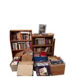 WOODEN BOOKSHELF AND OTHER BOOKSHELF W/ ASSORTMENT OF BOOKS: FORD PARTS, READER’S DIGEST, AND OTHERS; CASSETTE TAPES; VHS TAPES; PENS AND PENCILS; PEWTER STEM GLASS; CLEAR DRINKING GLASS; LIGHTHOUSE