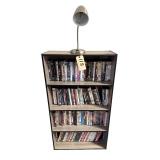 BOOKCASE W/ ELECTRIC LAMP AND ASSORTMENT OF DVDS TO INCLUDE MARLEY & ME, APOLLO 11, AMERICAN GANGSTER, AMERICAN SNIPER, BRUCE ALMIGHTY, THE BRIDESMAID, MRS. DOUBTFIRE, THE DEVIL WEARS PRADA, ETC.