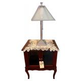 WOODEN STORAGE CABINET W/ 2 GLASS DOORS AND CABRIOLE LEGS - APPROX. 24” TALL X 19” WIDE X 15.5” DEEP; ELECTRIC TABLE LAMP