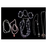 VINTAGE COSTUME JEWELRY LOT; TREE OF LIFE NECKLACE, CRUCIFIX PENDANT W SILVER TONE AND AMETHYST TYPE BEADS, A MULTI-STRAND PURPLE AND DARK GRAY FACETED GLASS BEAD STATEMENT NECKLACE, PINK CRYSTAL OR G
