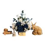 2 CERAMIC RABBIT FIGURINES, LINDA K. POWELL “SUMMER” PORCELAIN BELL, WOVEN BASKET W/ ARTIFICIAL FLORAL ARRANGEMENT