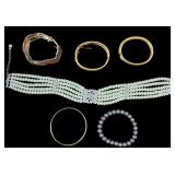 MULTI-STRAND PEARL CHOKER NECKLACE FEATURES ROWS OF WHITE IMITATION PEARLS ACCENTED WITH DECORATIVE RHINESTONE OR CRYSTAL SPACER BARS AND A CENTRAL FLORAL-SHAPED RHINESTONE, GRAY STRETCH PEARL BRACELE