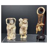 Hand-Carved Eskimos and Charms on Stand