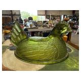 green hen on nest