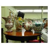 Lot of four hand painted, pottery jugs