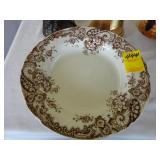 Four Edwardian brown and white ironstone plates