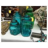 Three MCM teal canisters, along with another