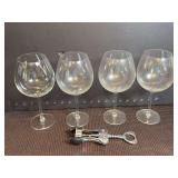 Four wine glasses and corkscrew