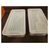 Two sets of stackable mini ice cube trays with a storage bin and scoop. One is missing the scoop.