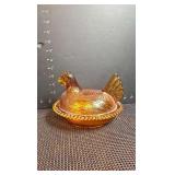 Vintage amber hen on a nest