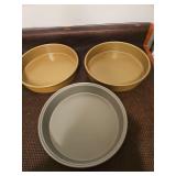 Three round 9in cake pans. Two are Calphalon brand.