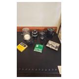 Camera lens and covers. Appear to be Nikon accessories.