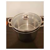 Stainless steel multi-cooker set with a steamer and pasta insert.