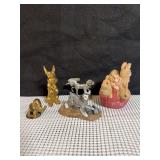 Collection of animal figurines including a brass elephant, brass dog, pewter horse, cold cast bronze dog, hand cast dog, and resin bunnies