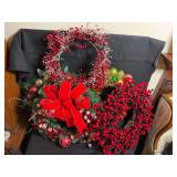 Five holiday wreaths and two over the door wreath hangers ￼