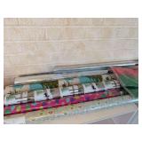 Six rolls of Christmas or Winter wrapping paper and two packages of red and green tissue paper