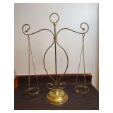 Metal Balance Scale Style Decorative Item with open metal rings to hold a glass dish or candle holder. Fixed arms that do not move with weight added to either side.