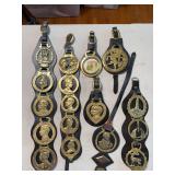 Collection of horse brasses (harness medallions) displayed on leather straps ￼