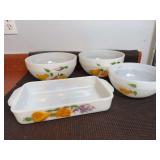 Anchor Hocking Fire-King milk glass baking dish and serving bowls in the 'Gay Fad Fruit' pattern.