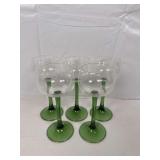 Set of five vintage wine glasses with clear bowls and green stems ￼