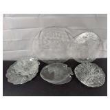Assorted glass serving trays and two cheese knives