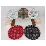 Glass appetizer serving tray, decorative plates, napkin rings, and a metal hot plate/trivet ￼